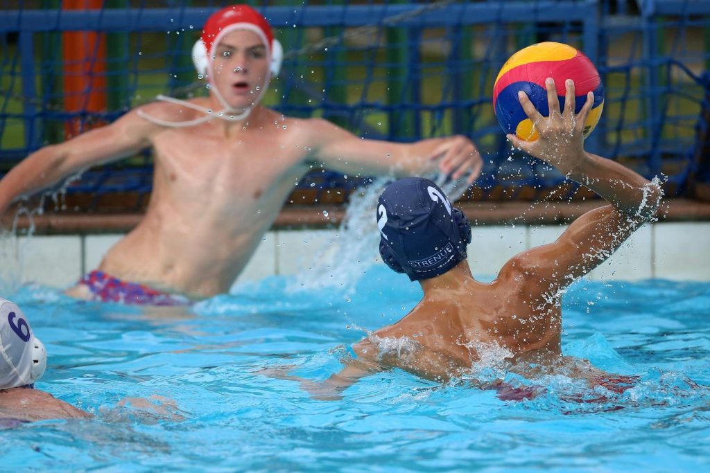 Competitive water polo game with athletes in action, showcasing intense moments.